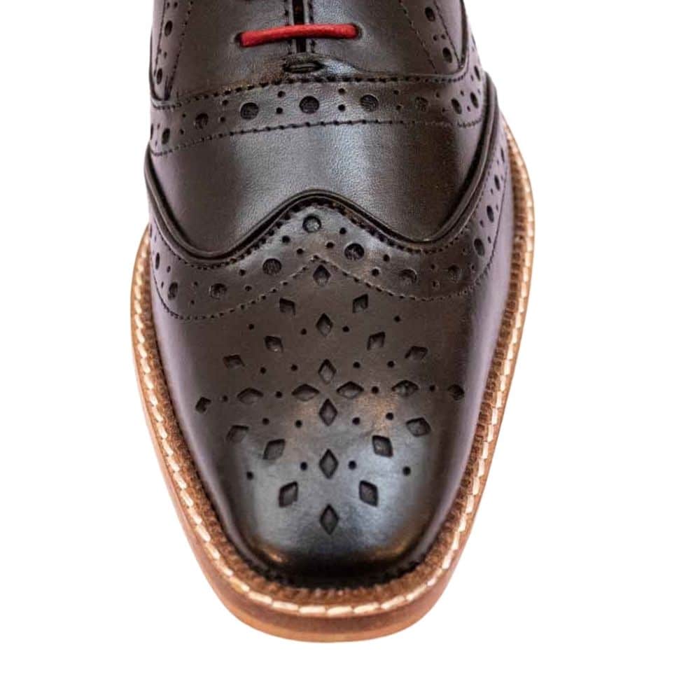 marc darcy black shoe close up